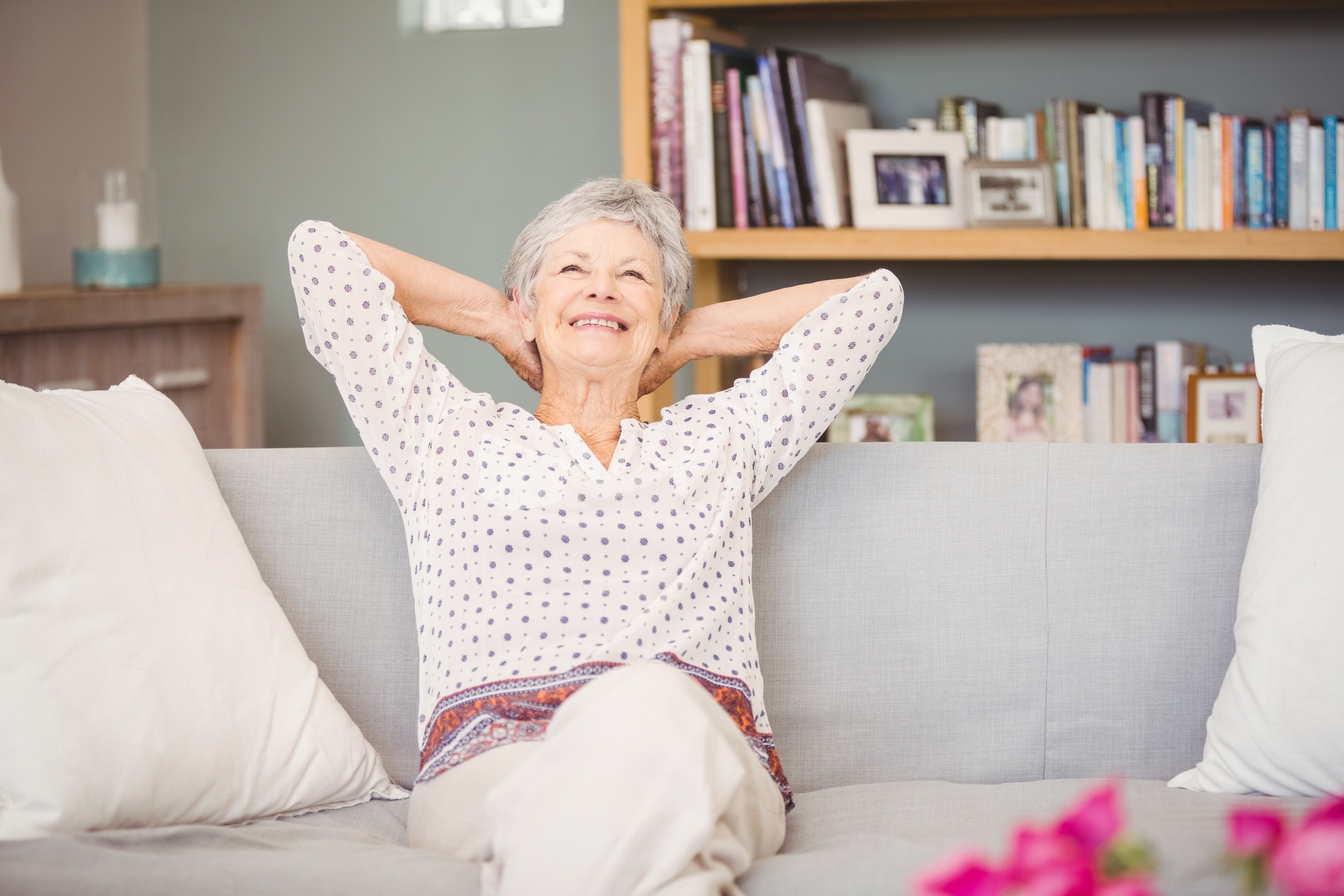 Senior woman relaxes in a clean home after spring cleaning.